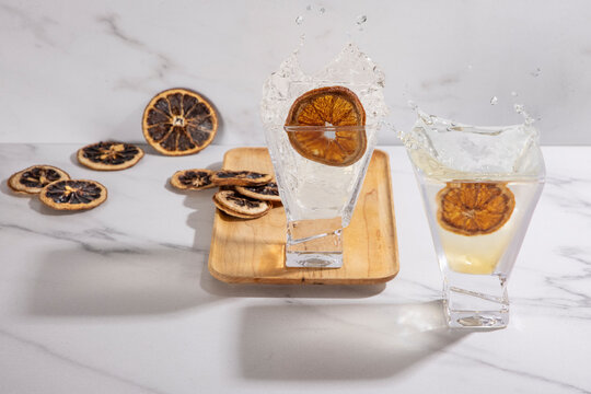 2 cocktails on wood with splashes