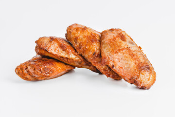 Chicken wings fried until half cooked, semi-finished product with fresh herbs on a white background. Fast food. Fast cooking.Quick cooking at home. Copy space.Fast homemade food.Raw chicken meat.