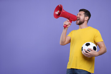 Emotional sports fan with ball and megaphone on purple background. Space for text