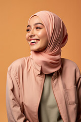 Fototapeta premium Portrait of a beautiful arab woman smiling, wearing hijab