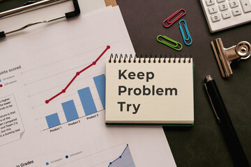 There is notebook with the word Keep Problem Try. It is as an eye-catching image.