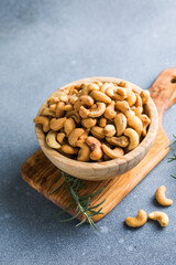 wooden plate filled with cashew nuts, Cashew Nut in a Black Bowl