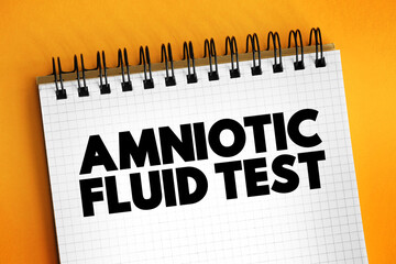 Amniotic Fluid Test is a medical procedure used primarily in the prenatal diagnosis of genetic conditions, text on notepad