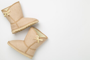 Beautiful woman boots on color background,top view