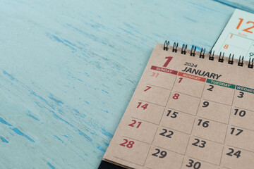 close up of calendar on the blue table background, planning for business meeting or travel planning concept - obrazy, fototapety, plakaty