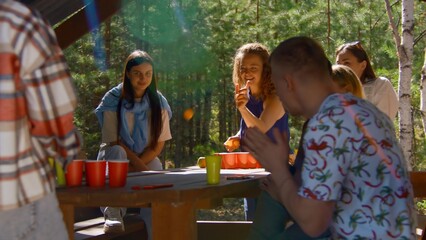 Woman plays beer pong. Stock footage. Beautiful young woman wins at beer pong. Friends rejoice at victory in beer pong in nature in summer