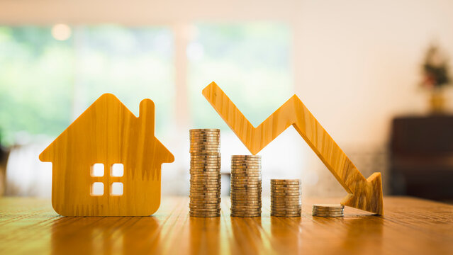 Wood house and row of coin money on wood table and , selective focus, Planning to buy property. Choose what's the best. A symbol for construction ,ecology, loan concepts