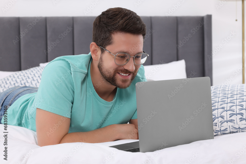 Canvas Prints Happy man having video chat via laptop in bedroom