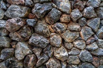 Rough stones cemented into a wall
