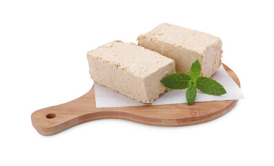 Board with pieces of tasty halva and mint isolated on white