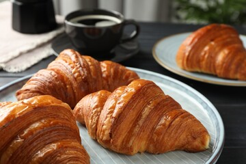 Delicious fresh croissants on dark table indoors, closeup