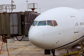 Aircraft maintenance commercial airplane parked at airport before next flight at boarding bridge
