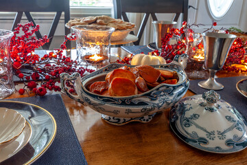 Sweet yams on a holiday table with duck, cranberry sauce