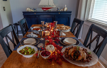 Roasted duck, stuffing, brussels sprouts, and yams on a holiday table