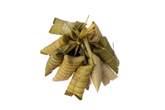 A group of lepet ketan on white background. Lepet ketan is a traditional Indonesian sticky rice cake made from a mixture of glutinous rice, grated coconut, peanuts, and wrapped in coconut leaves.