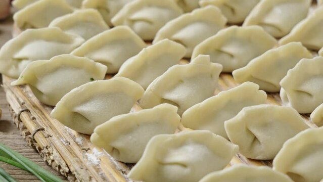 making dumplings in the kitchen. traditional food raw dimplings