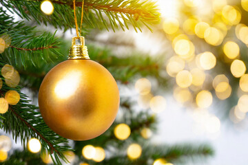 Merry Christmas and happy new year concept, Closeup of golden bauble hanging from a decorate background