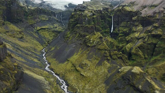 Flying through scenic canyon in Iceland viewing waterfalls in Múlagljúfur Canyon.