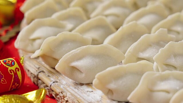making dumplings in Chinese new year. traditional food raw dimplings