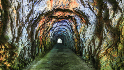 Simple,Pristine and spectacular rock tunnel.Strange flaky rocks and vibrant colors form a scenic...