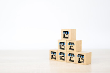 Franchise or franchising business store icon on cube wooden block stack pyramid for strategy...
