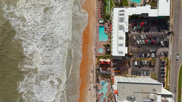 Aerial overhead droen video Ormond Beach Florida. View of beach erosion hotels and surf waves