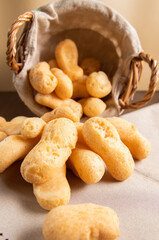 Traditional Brazilian starch biscuit falling from a basket into table