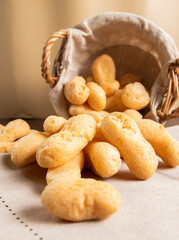Traditional Brazilian starch biscuit falling from a basket into table