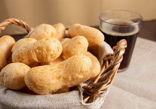 Close Up Brazilian starch biscuit in a basket( biscoito polvilho made with tapioca or cassava flour ). Typical Brazilian biscuit with coffee in a american glass
