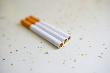 Cigarette isolated on a wooden background. Tobacco cigarette.