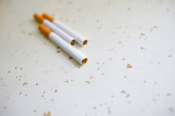 Cigarette isolated on a wooden background. Tobacco cigarette.