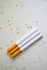 Close up of a cigarettes . Cigarette filter tubes on wooden background.
