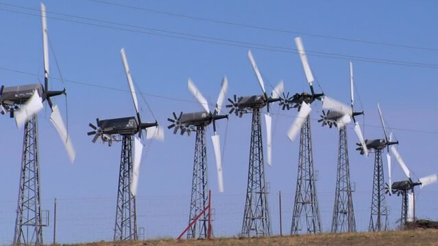 Wind turbines in Altamont Pass wind farm under blue sky in Northern California, United States