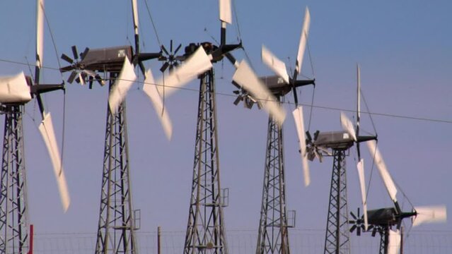 Wind turbines in Altamont Pass wind farm under blue sky on a sunny day in California, United States