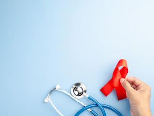 AIDS prevention campaign for red December showcases a stethoscope and red ribbon against a blue...