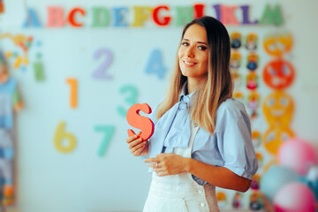 Speech Therapist Holds the Letter S in Her Hand. Professional logopedic expert teaching about...