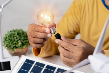 Energy engineers people holding light bulbs while thinking. Inspiration and imagination in...