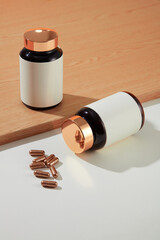 Two white-label medicine bottles are placed on the table with hard capsules. Using functional foods...