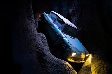 Naklejka premium JAPAN - NOV 13, 2023: The Flying Ford Anglia Vintage Car From Harry Potter stuck into the Whomping Willow forbidden forest at Warner Bros. Studio Tour Tokyo, The Wizarding World landmark