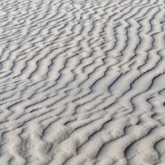 Sand texture dunes desert pattern waves background close up beach tide ripples