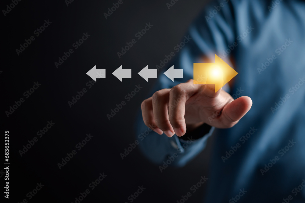 Leinwandbilder point to orange arrow and different direction facing opposite direction with white arrow for busines