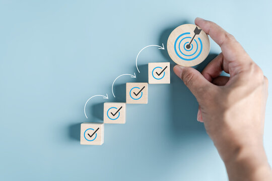 Business growth success achievement concept, hand arranging wooden block stacking as step stair or ladder for planning development leadership and customer target group concept..