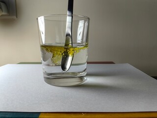 Mix olive oil with a spoon in water