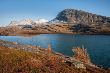 Autumn colors in the Swedish mountains by a lake on a beautiful September evening, Kiruna region, Swedish Lapland