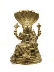 golden statue of lord vishnu avatar, narasimha lion faced with multiple hands sitting on a snake...