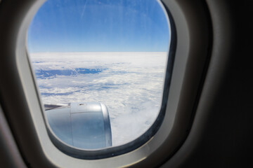Clouds and sky as seen through window of an aircraft