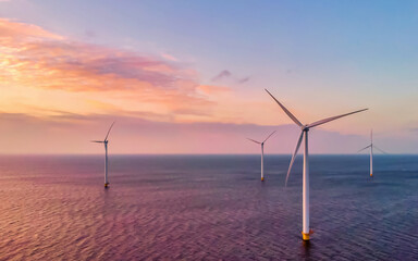 Windmill turbines in the Netherlands at sunset, windmill turbine park in the ocean the biggest wind park in the Netherlands