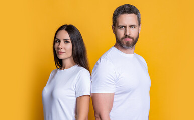 Obraz premium Millennial man and woman wearing white tshirt. Casual style of millennial couple. Boyfriend girlfriend. Couple of man and woman isolated on yellow. Family couple relationship. Stylish casual people