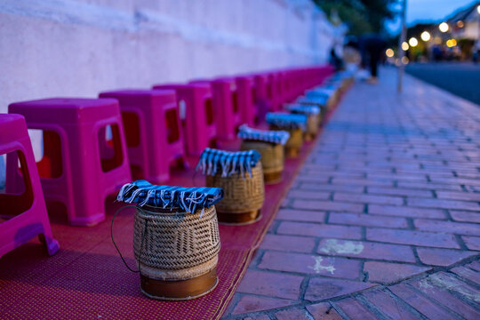 Buddhist Alms Giving Ceremony In Early Morning. Monks Walk To Collect Alms And Offerings. Sticky Rice Morning Alms Giving Is Held Every Day In Luang Prabang. Traditional Ritual Of Alms Giving In Laos.