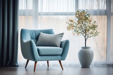 A mid-century blue armchair next to the window is decorated with white curtains.
